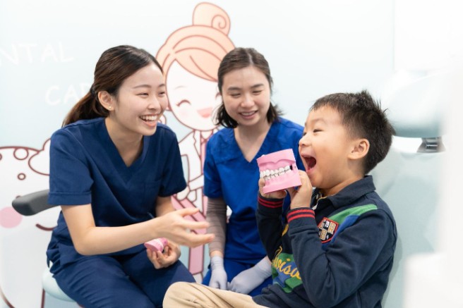 Home Dental team explaining oral care to a child patient in Hong Kong